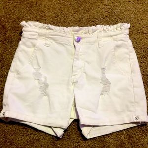 Ripped white shorts.